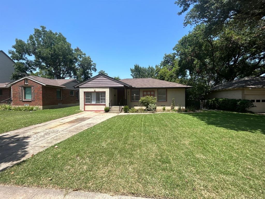 a front view of house with yard and green space