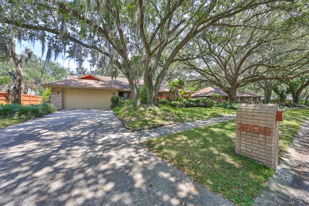 a view of a house with a yard and tree s