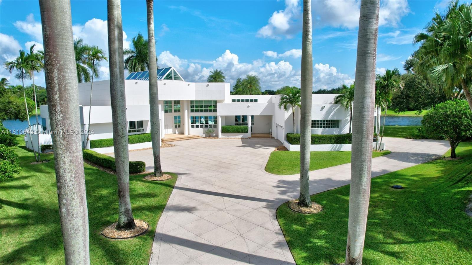 a view of a park with potted plants and palm trees