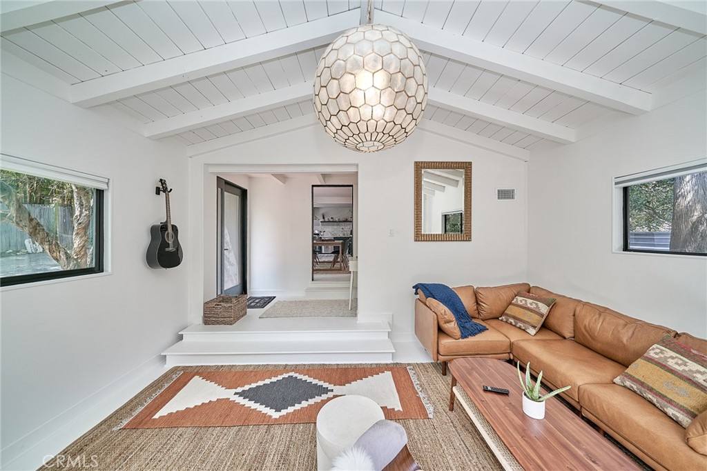 a living room with furniture and wall paintings