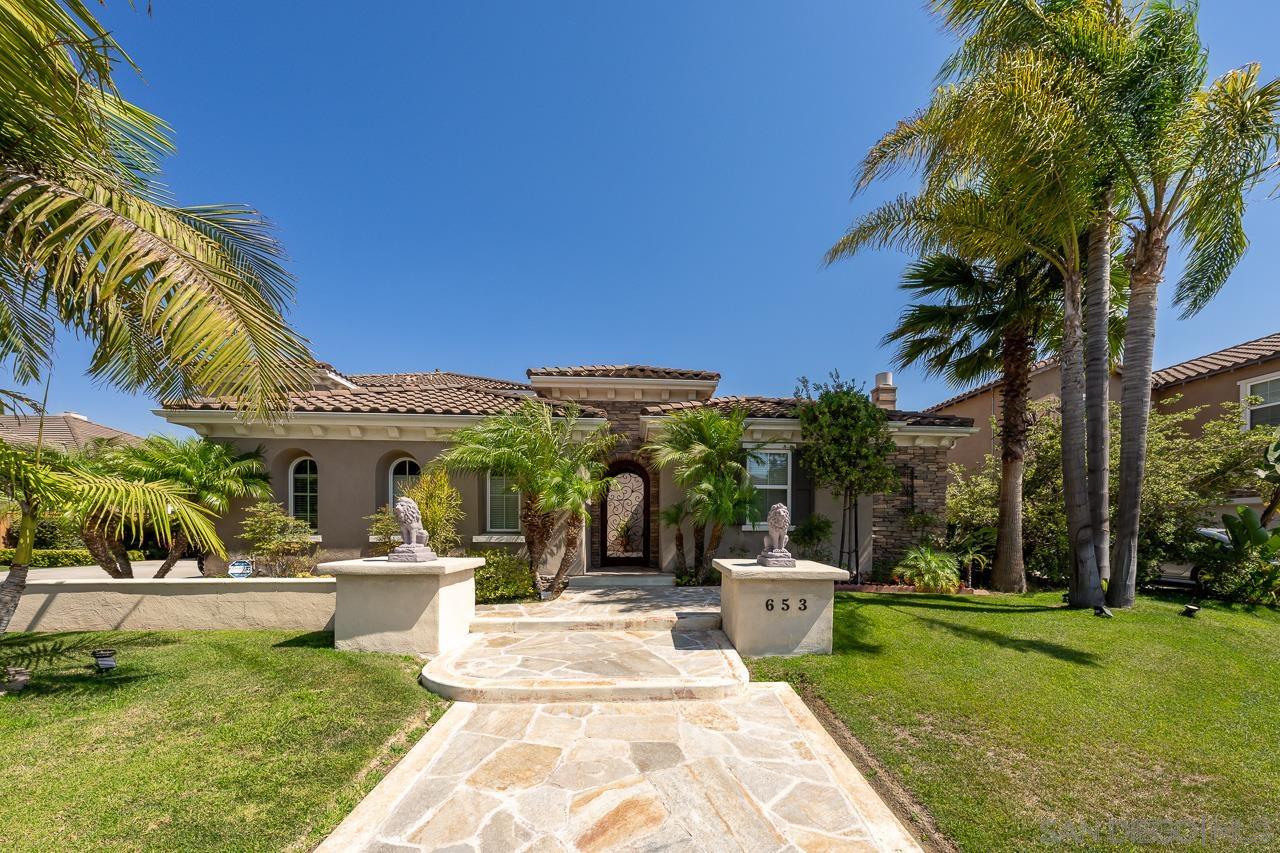 a view of a patio with table and chairs potted plants and palm trees