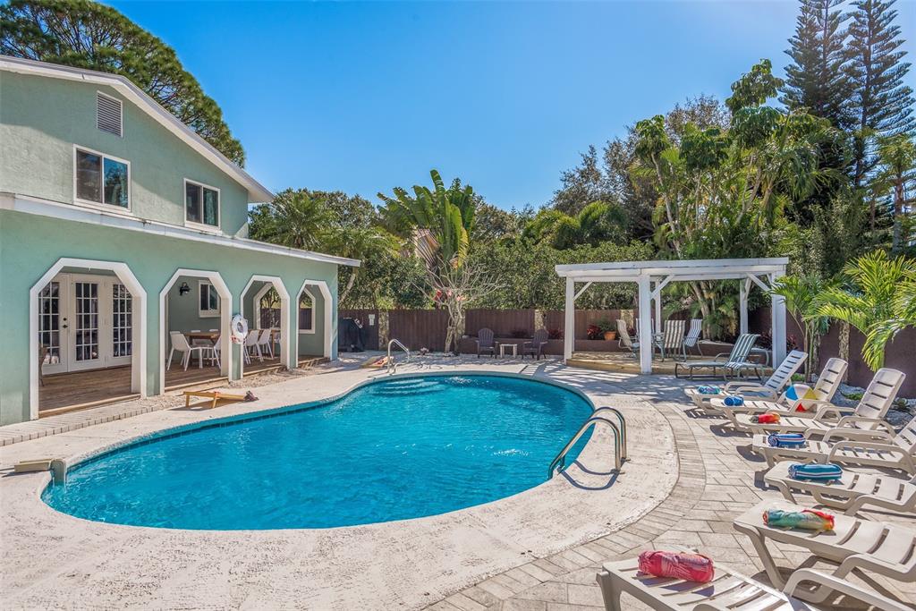 a view of a house with swimming pool and sitting area