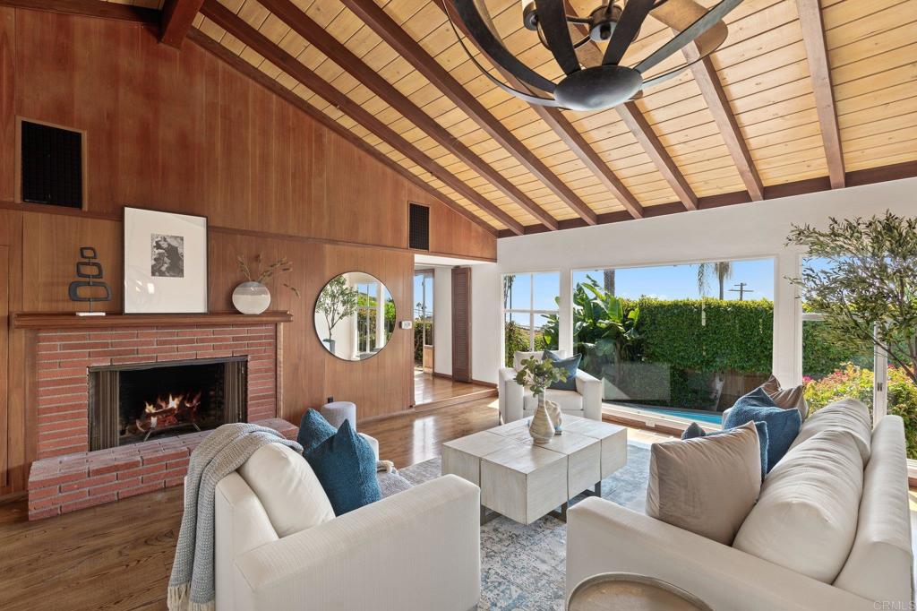 a living room with furniture a fireplace and a flat screen tv