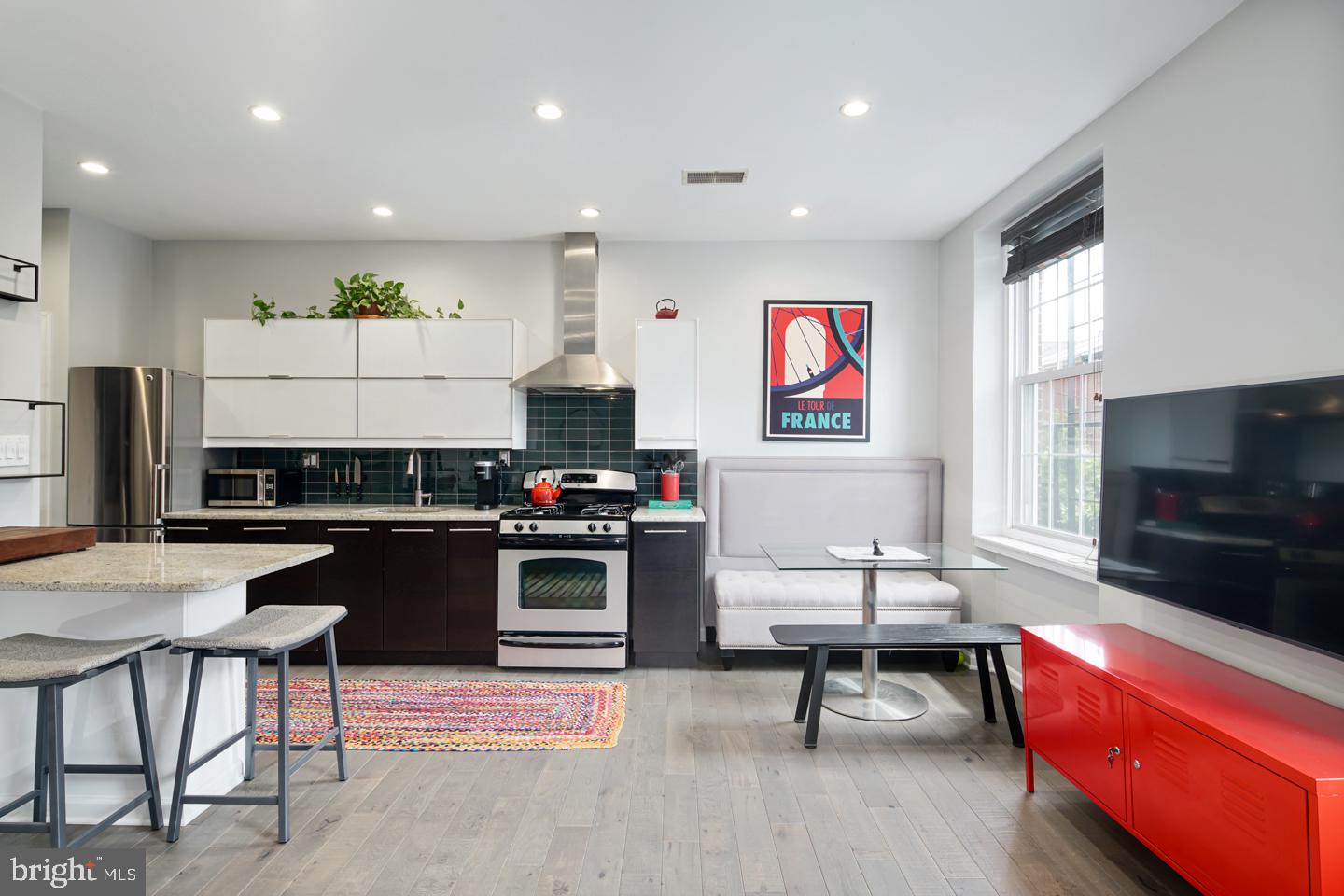 a living room with furniture a rug and a flat screen tv