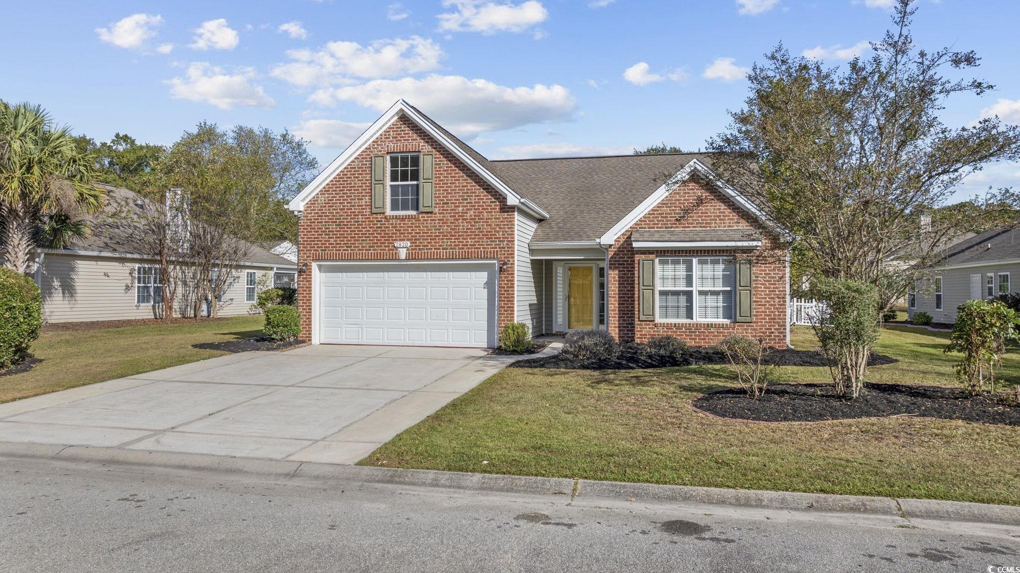 View of property with a garage and a front yard