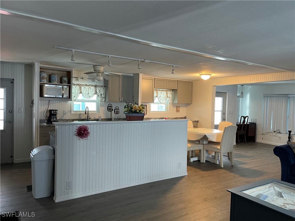 a living room with furniture a dining table and kitchen view