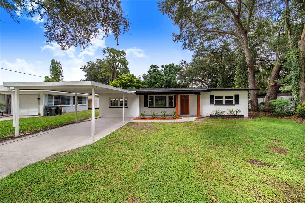 a front view of house with yard and green space