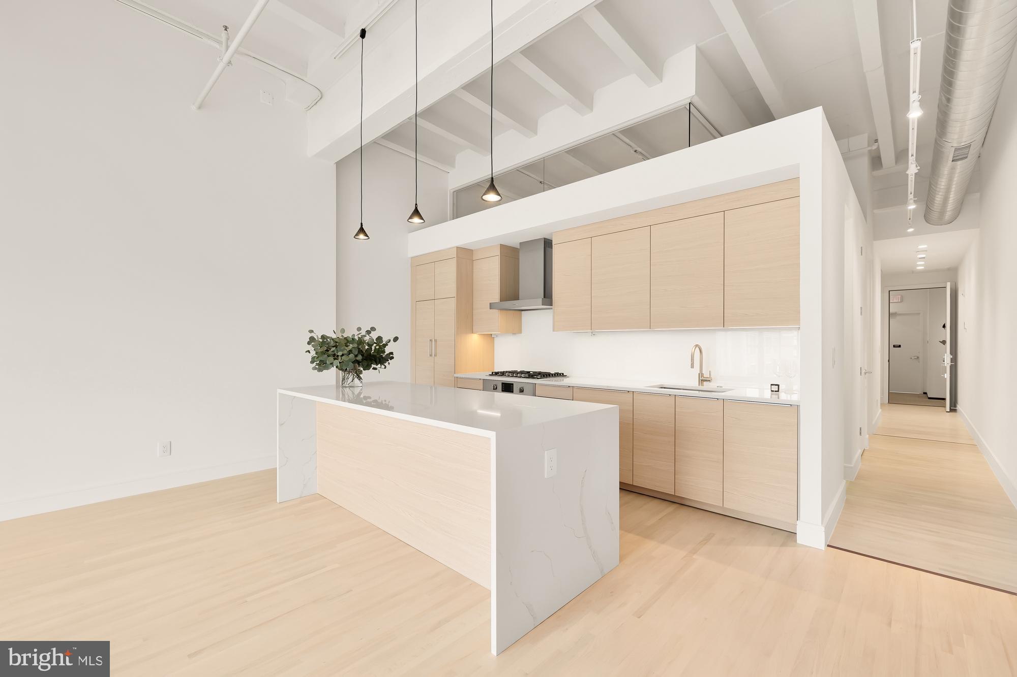 a large white kitchen with cabinets