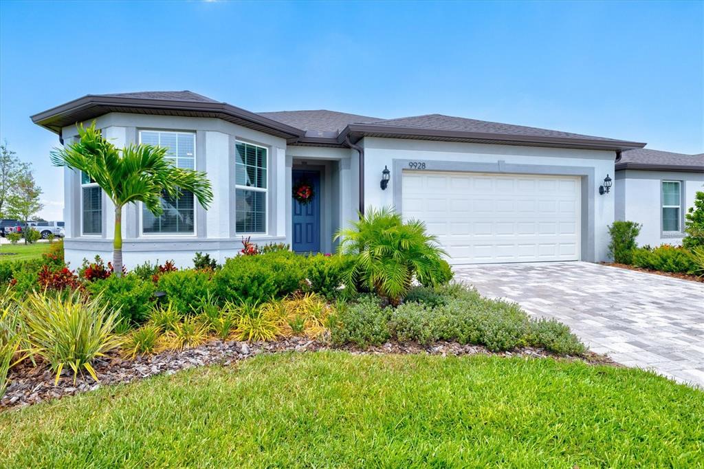 a front view of a house with a yard and garage