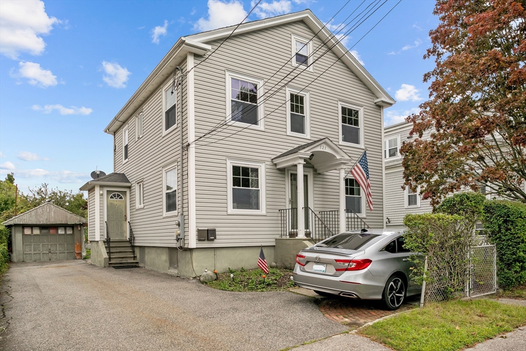 a front view of a house with a garden