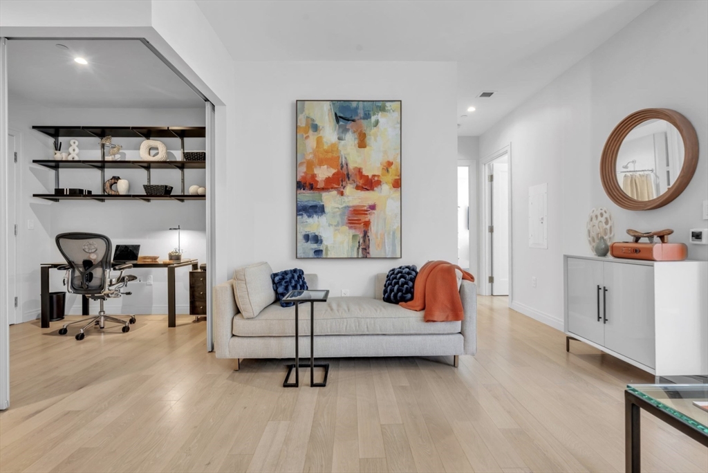 a living room with furniture and a mirror