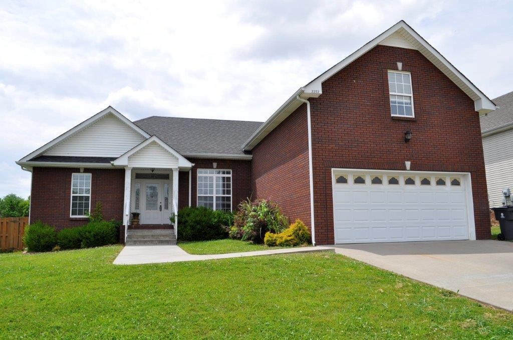 a front view of a house with a yard and garage