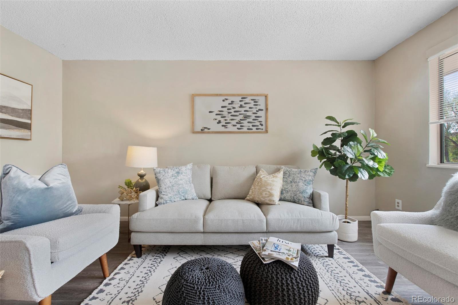 a living room with furniture and a potted plant