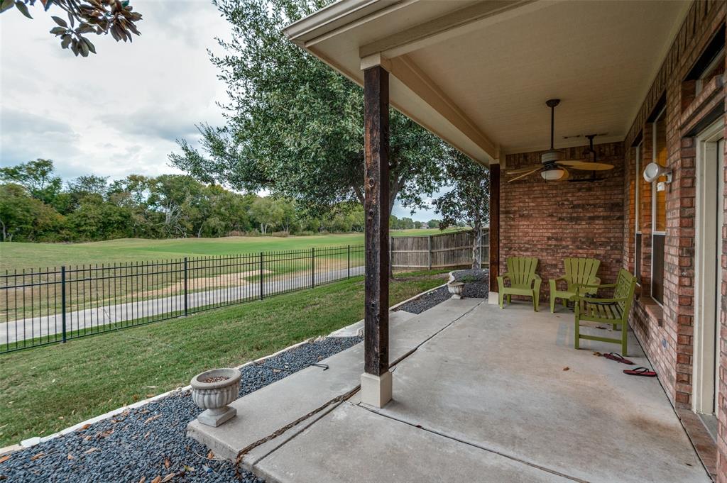 a view of a porch with a table and chairs