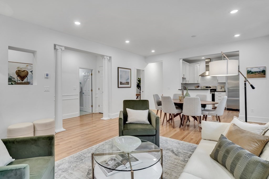 a living room with furniture and kitchen view