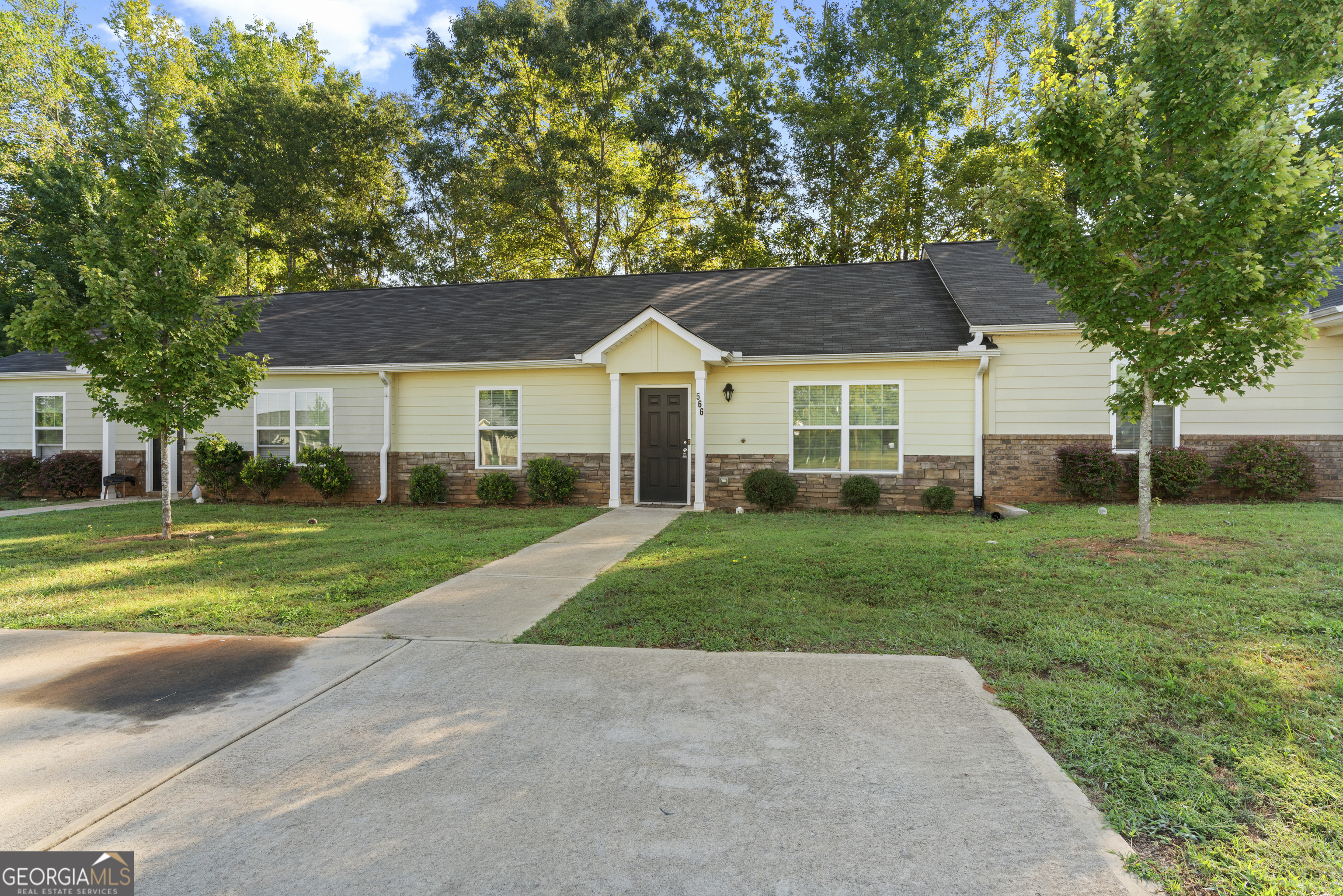 a front view of a house with a yard