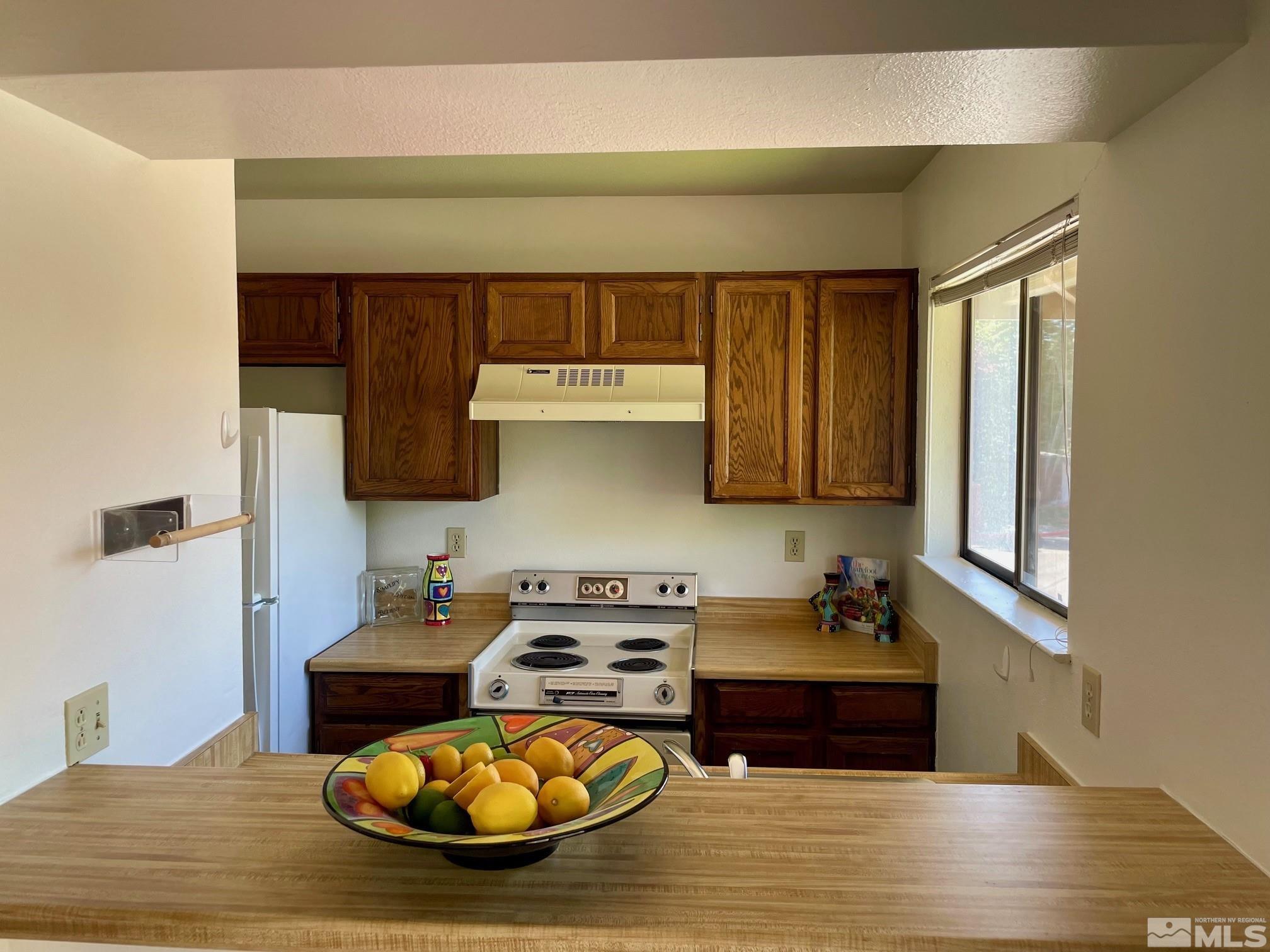 a kitchen with a sink and a stove top oven