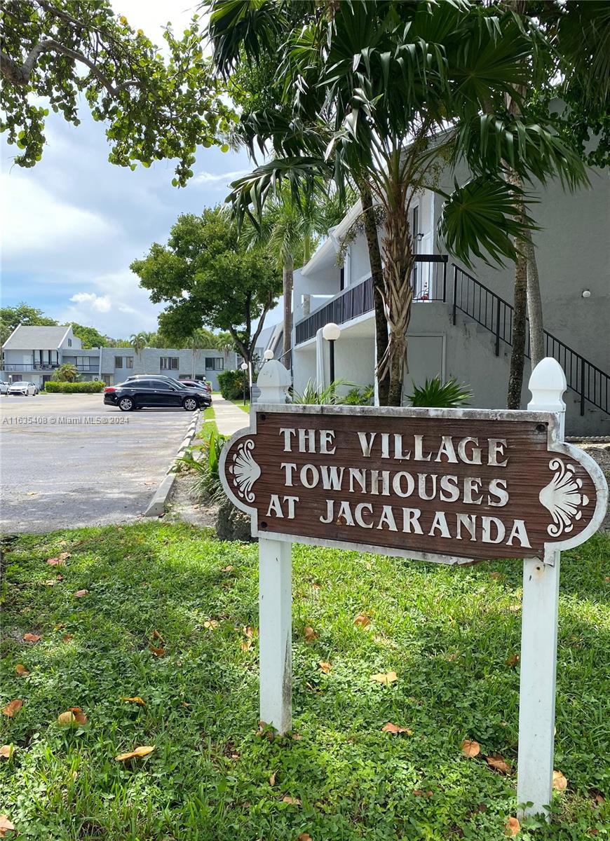 a street sign that is sitting in the middle of a yard