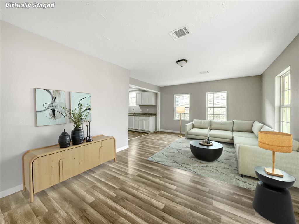 a living room with furniture and a potted plant