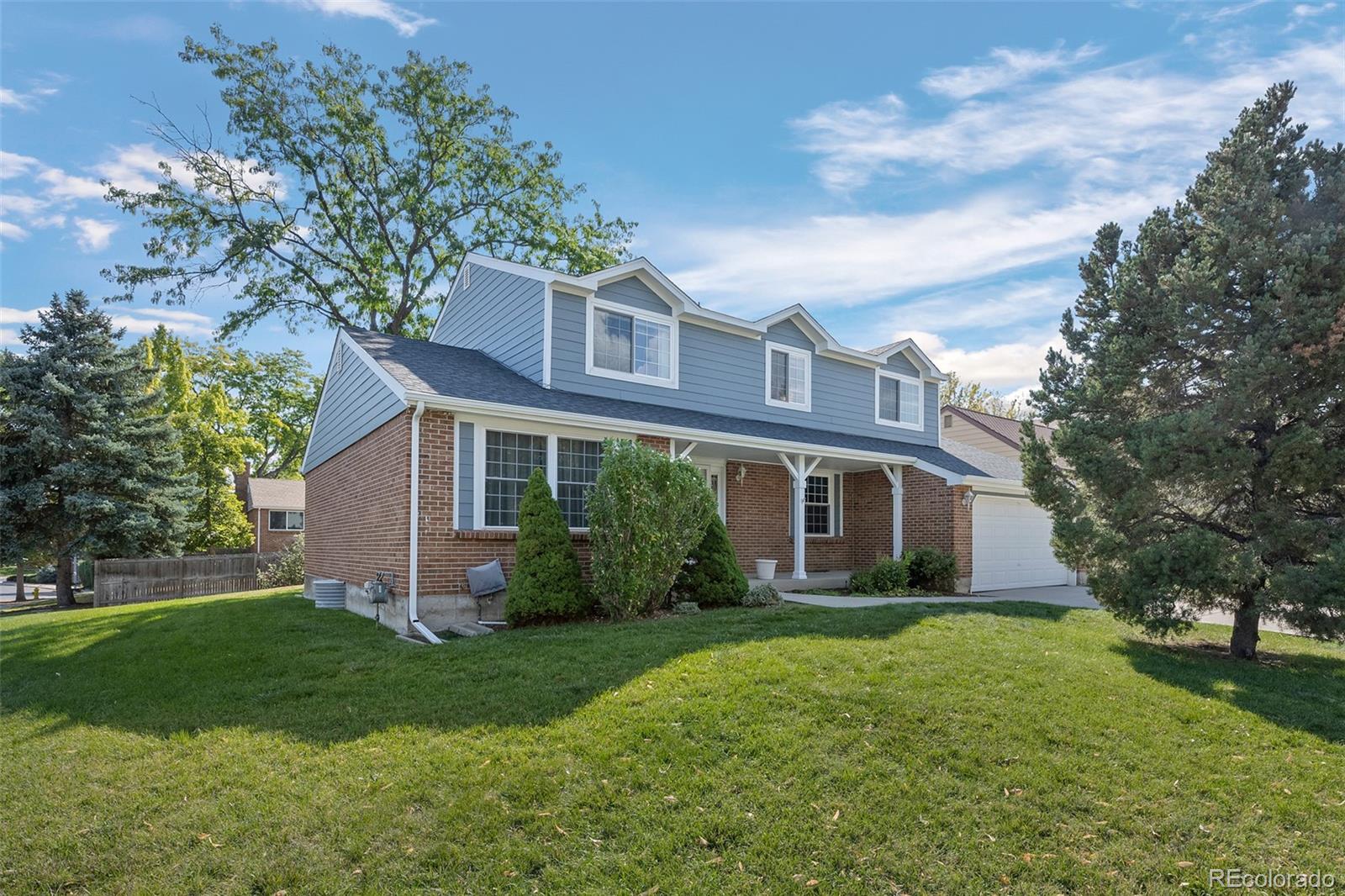 a front view of house with yard and green space