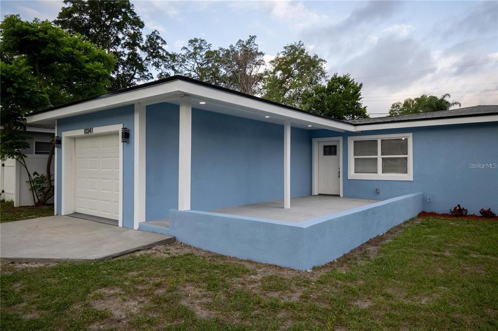 a view of a house with a yard and garage