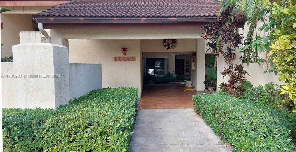 a front view of a house with garden