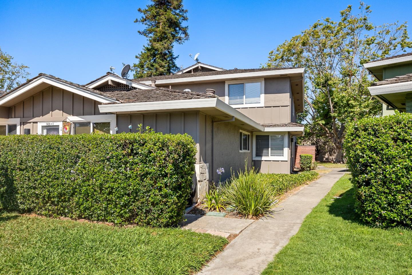 a front view of a house with a garden