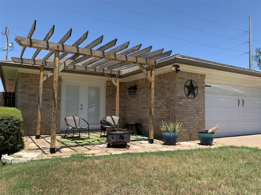 a view of a house with yard and chairs