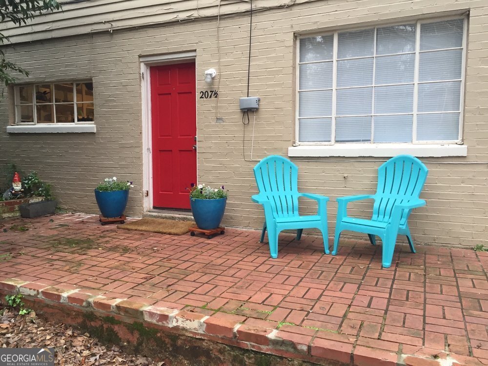 a view of a chair and table in back of the house