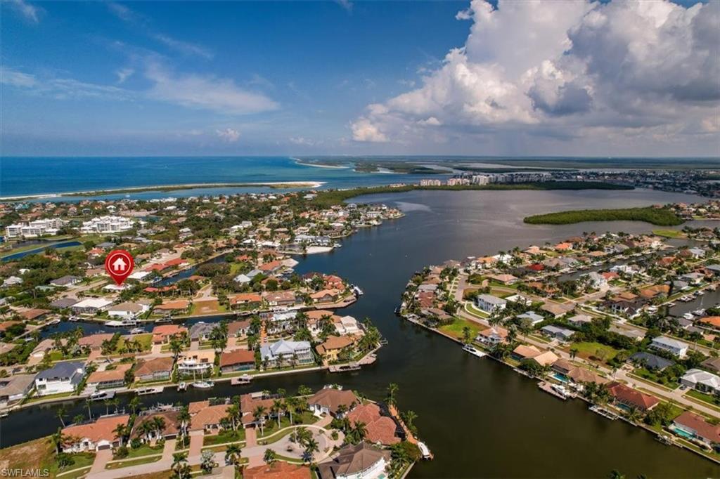 Birds eye view of property with a water view