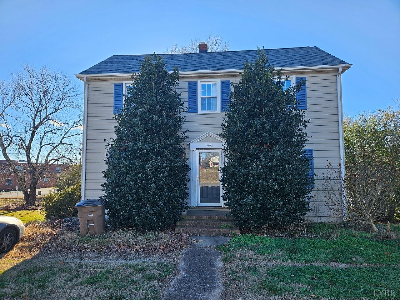 a front view of house with yard and green space