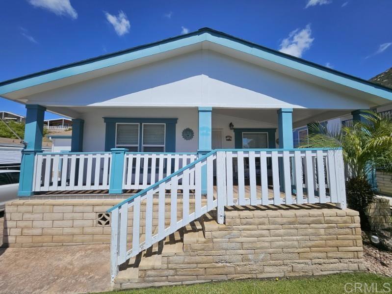 a view of a house with wooden deck