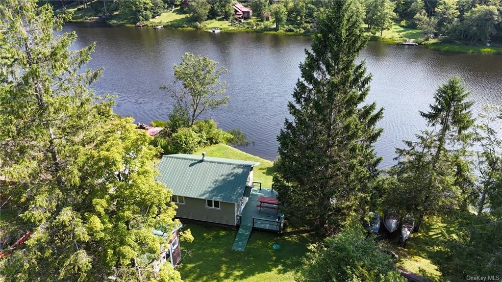 an aerial view of a house with outdoor space and a lake view