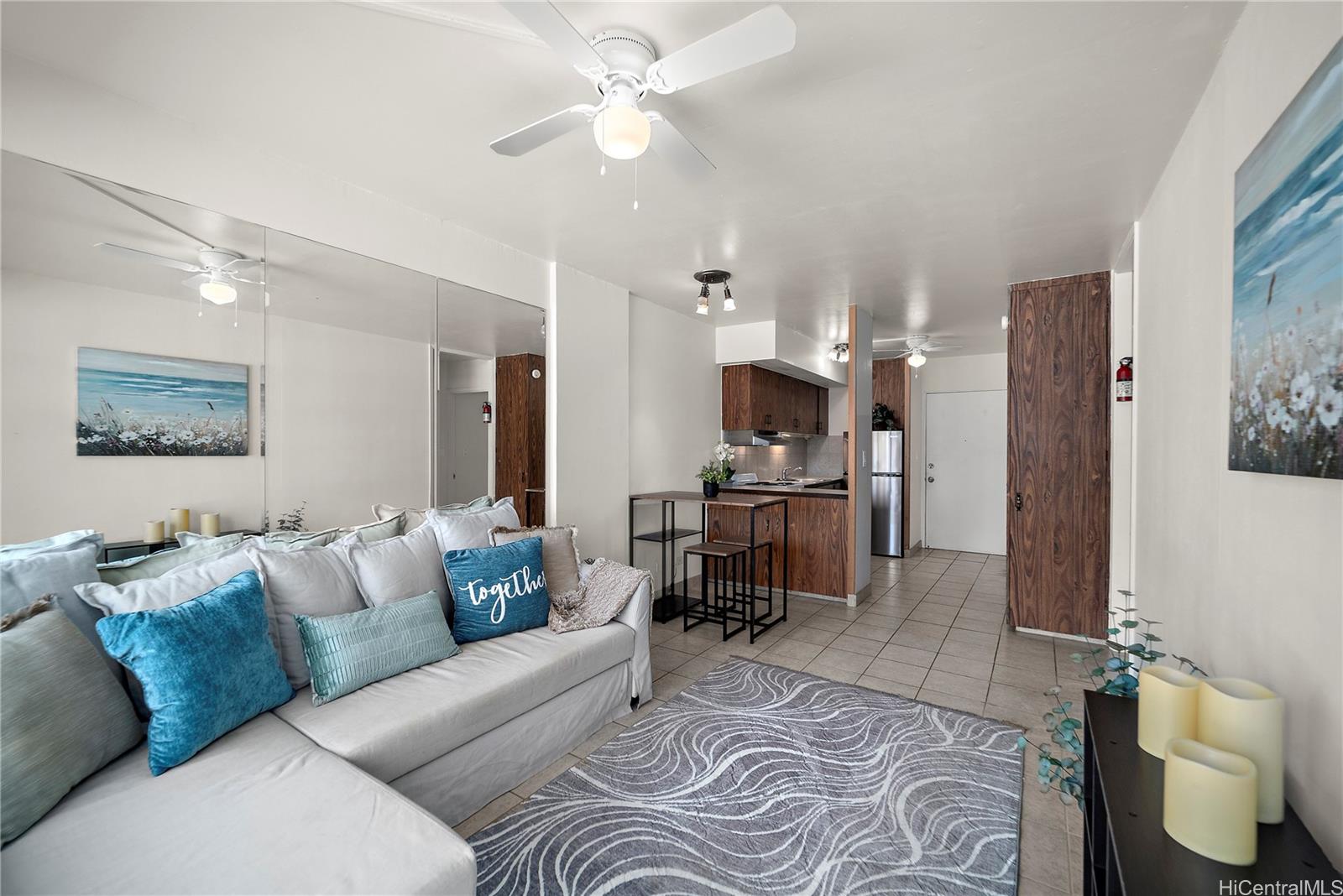 a living room with furniture and kitchen view