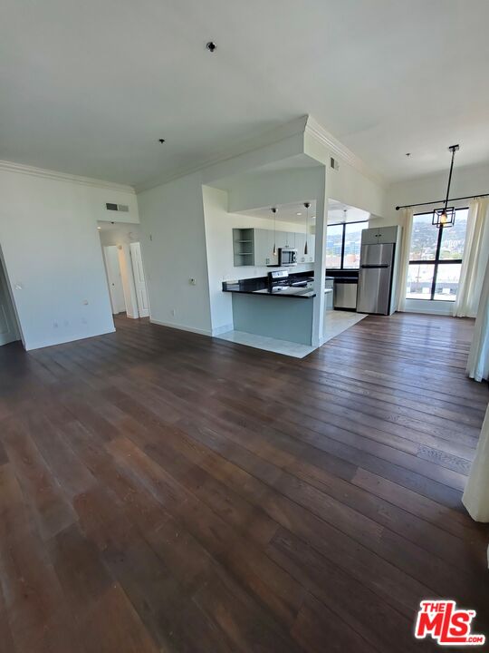 a view of a living room and kitchen