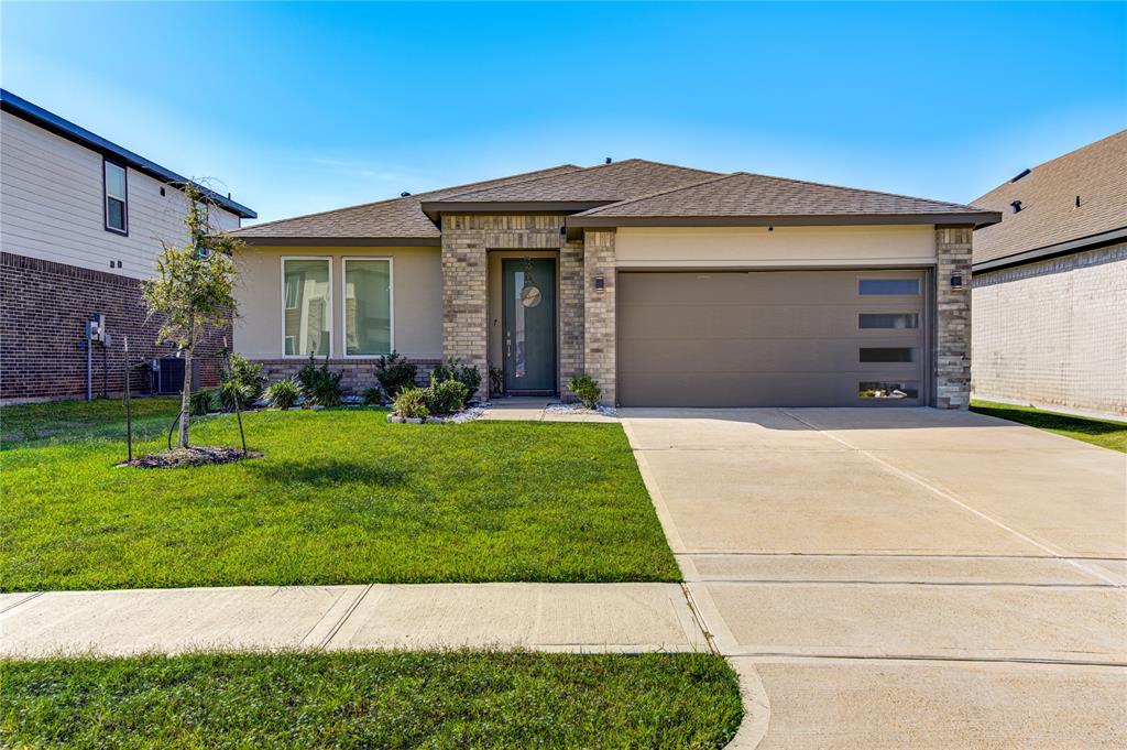 a front view of a house with a yard and garage