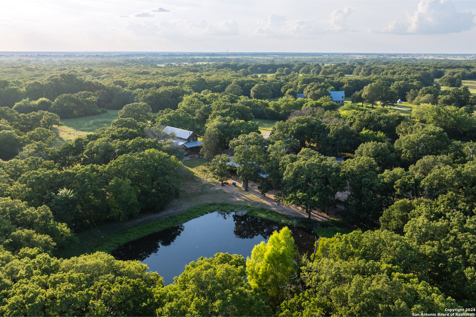 an aerial view of lake residential house with outdoor space and trees