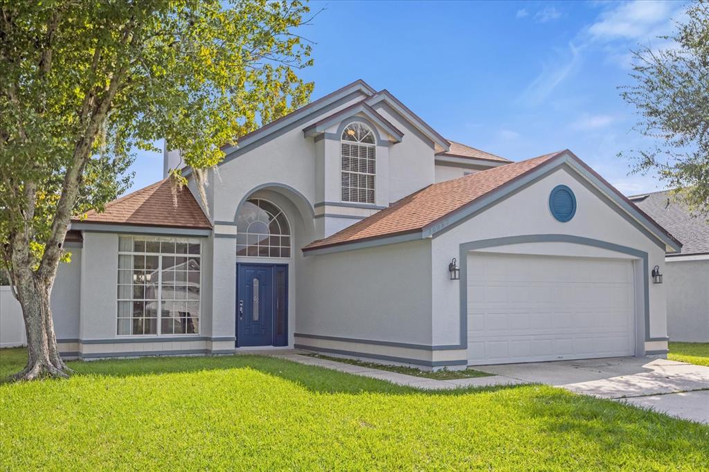 a front view of a house with a yard and garage