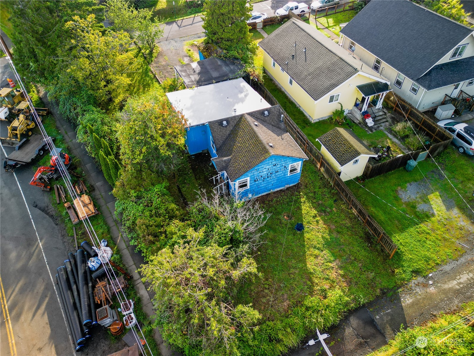 an aerial view of a house with garden space and street view