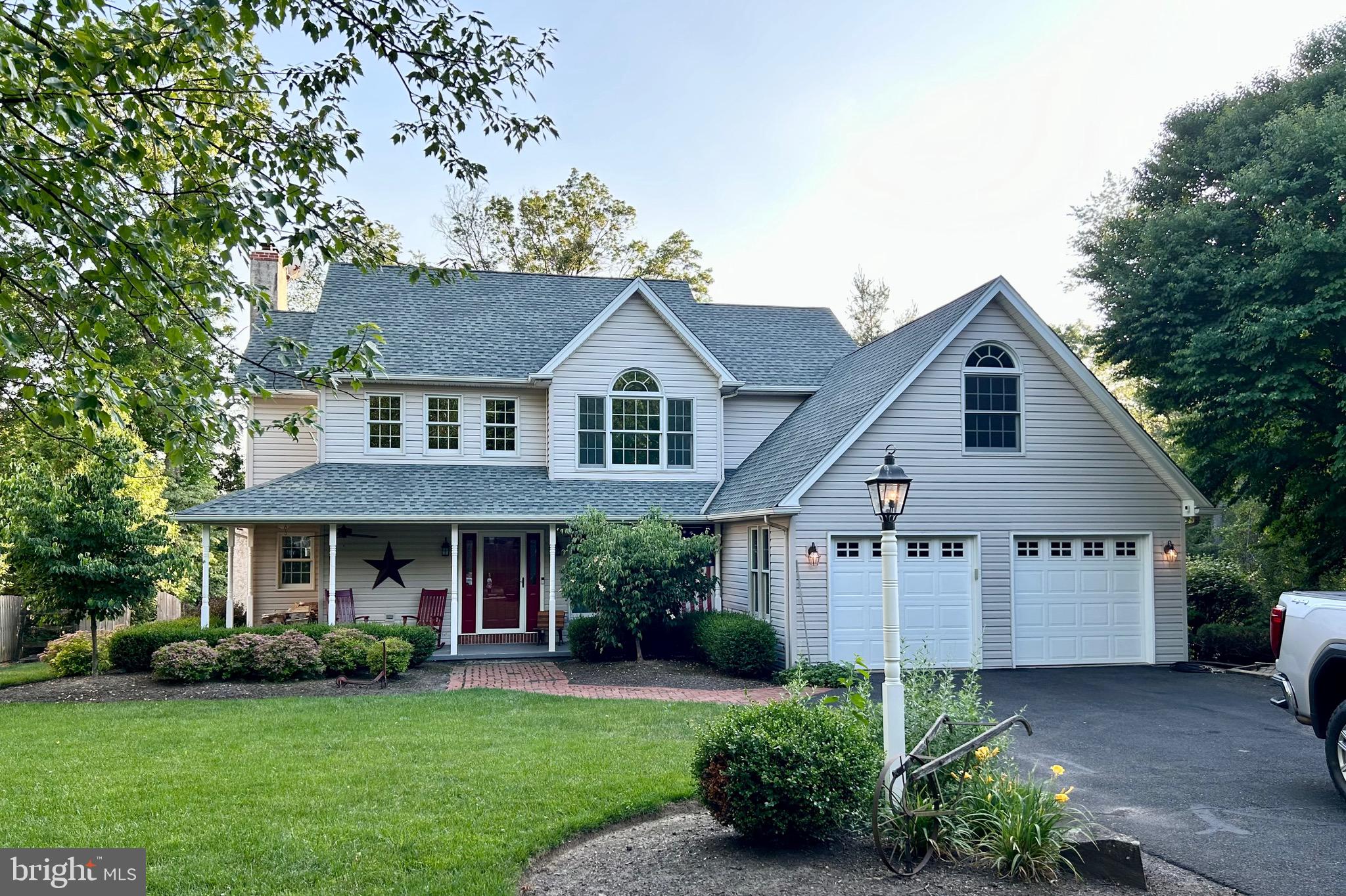 a front view of a house with a garden and plants