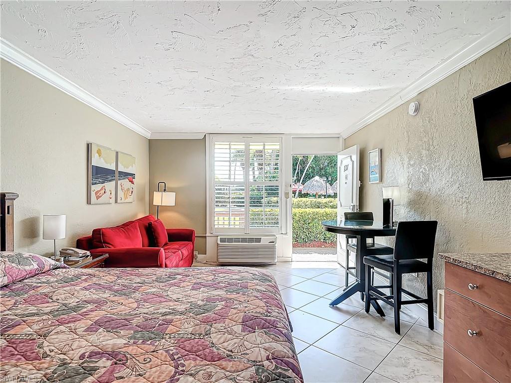 a living room with furniture a flat screen tv and a table