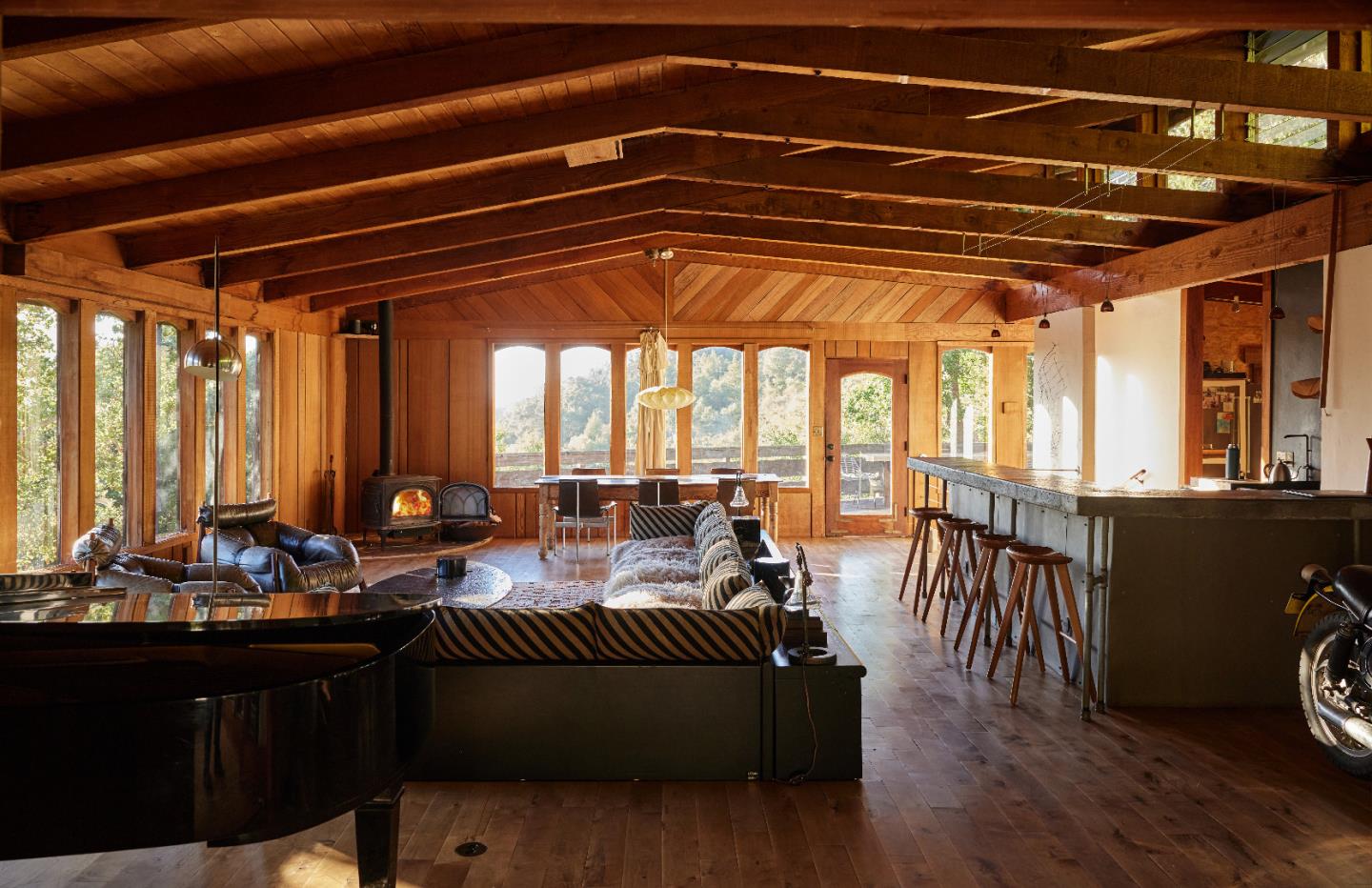 a living room with furniture and floor to ceiling window