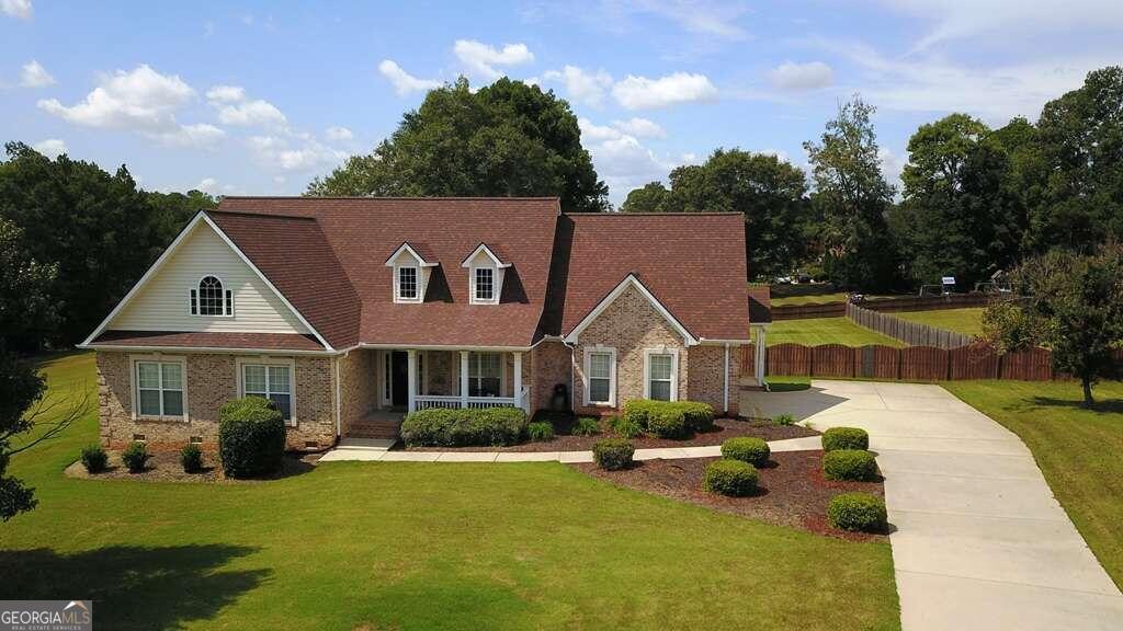 a front view of a house with swimming pool having outdoor seating