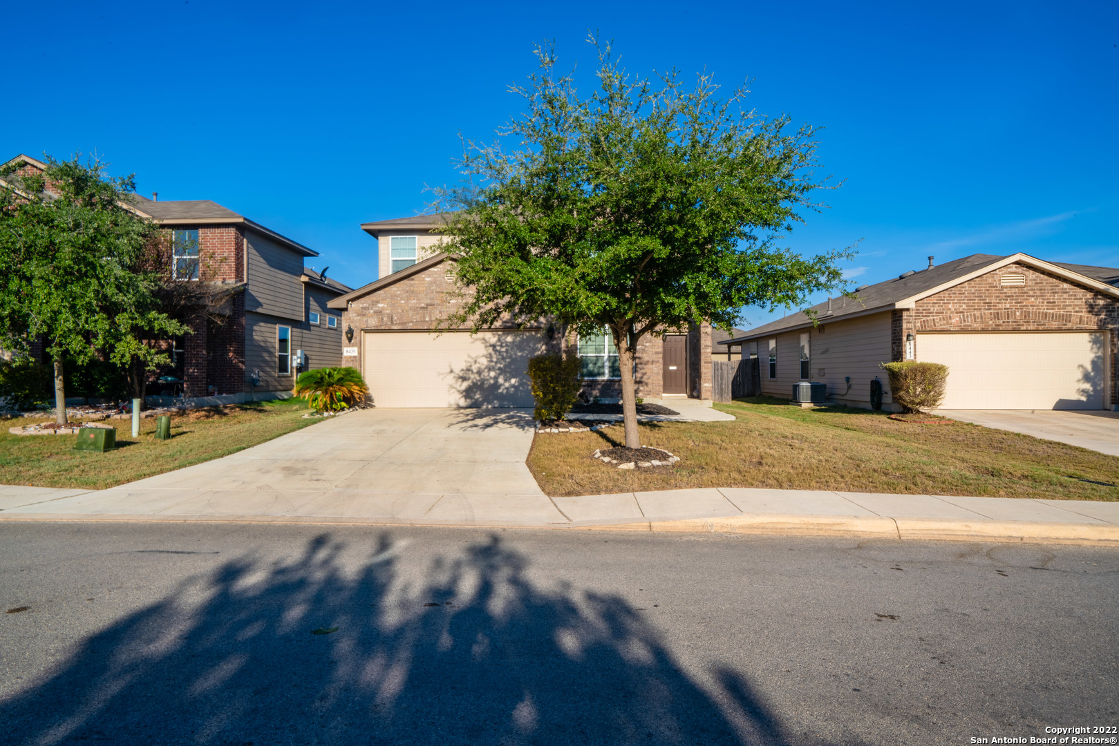 a view of a house with a yard and garage