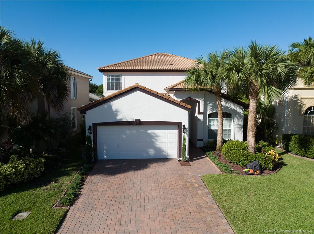 a front view of a house with a yard and garage