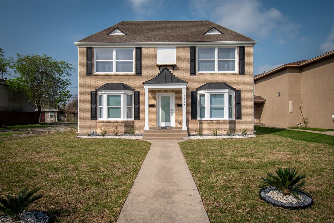 a front view of a house with a yard