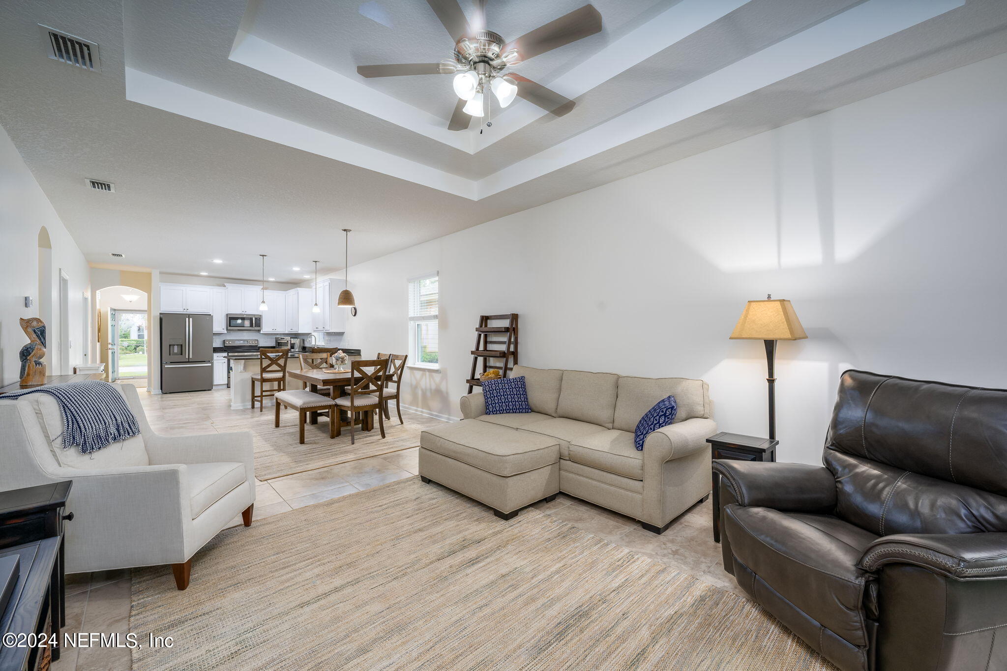 a living room with furniture and a chandelier