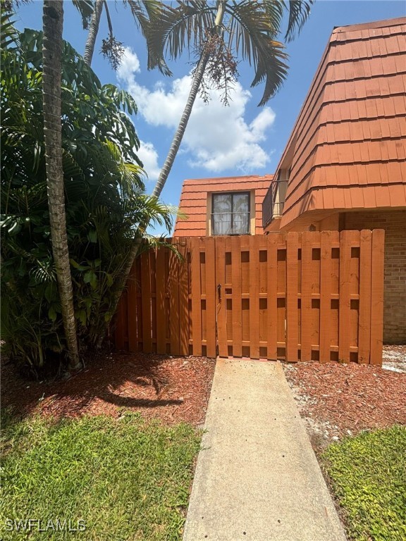 a view of a house with a wooden fence