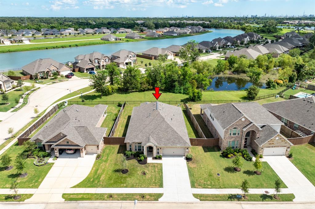 an aerial view of a house with garden space and lake view