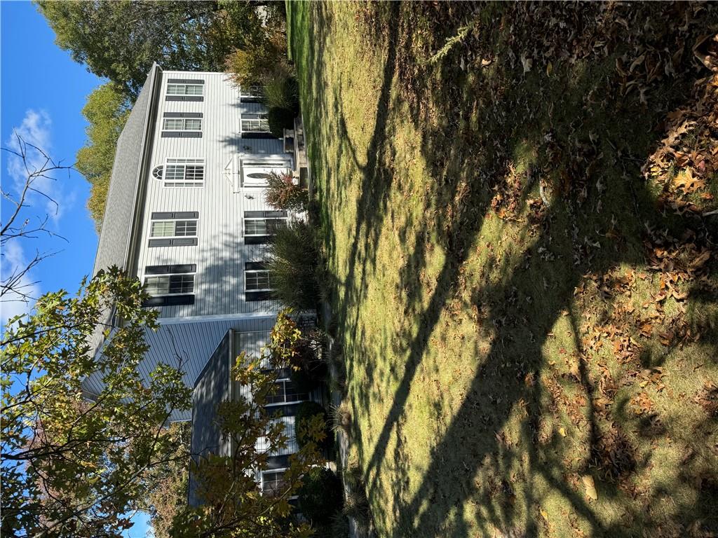 a view of a white house with a swimming pool